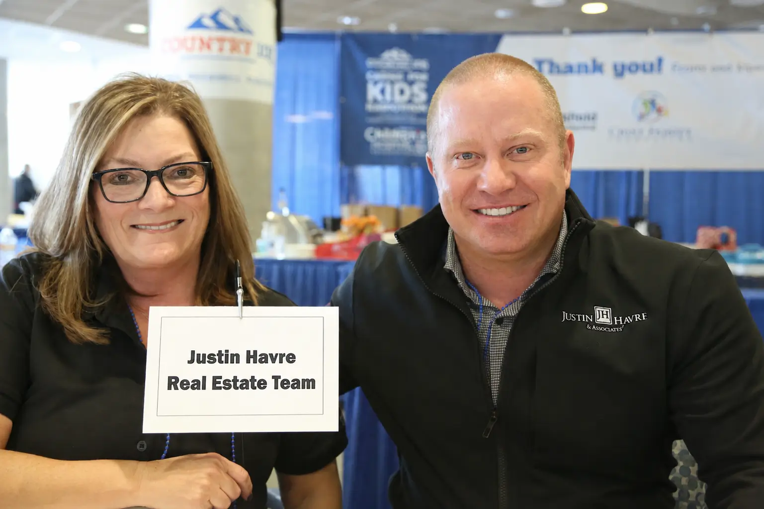 Justin Havre and a member of the Justin Havre Real Estate Team at a charitable community event
